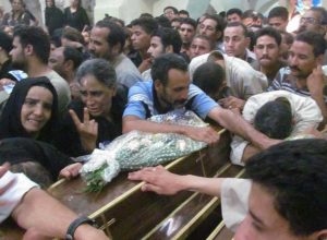 Mourners at funeral for four Copts on Sunday (July 7). (Morning Star News photo)