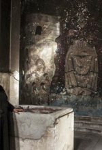 Priest examining damaged church building in Minya Governorate, Egypt. (Watani)