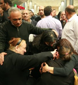 Ezzat Hakim Atallah's widow, Ragaa Abdallah (with ponytail) collapses with grief upon arrival to airport in Cairo. (Morning Star News)