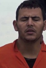 One of the victims prays before he and 20 other men are killed. (Screen-save Morning Star News)