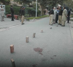 Police inspect site where Christian worker Birgitta Almby was shot in Lahore by suspected Islamic extremists.