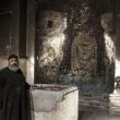 Priest examining damaged church building in Minya Governorate, Egypt. (Watani)