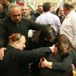 Ezzat Hakim Atallah's widow, Ragaa Abdallah (with ponytail) collapses with grief upon arrival to airport in Cairo. (Morning Star News)