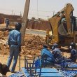 Police watch as Sudanese Church of Christ building in Omdurman is demolished. (Morning Star News)