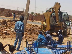 Police watch as Sudanese Church of Christ building in Omdurman is demolished. (Morning Star News)