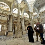 Rights activist Mina Thabet (center) and others examine church building set ablaze on Aug. 14, 2013. (Morning Star News)