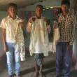Irma Markami and his sons with bloodied and torn clothing. (Morning Star News)