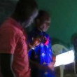 A pastor leads a Christian meeting by flashlight at damaged church building in Niamey, Niger. (RUN International).jpg