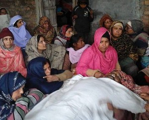 Loved ones keep vigil over the body of Liaqat Masih at home. (Morning Star News)