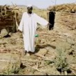 A relative of two children killed on May 1 in Heiban points to the site where a government bomb hit. (Nuba Reports)