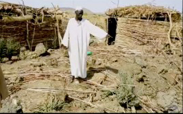 A relative of two children killed on May 1 in Heiban points to the site where a government bomb hit. (Nuba Reports)