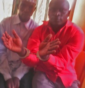Hassan Muwanguzi (handcuffed) with accuser Nghangha Mubakali during police investigation to stir up Muslim hostility. (Morning Star News)