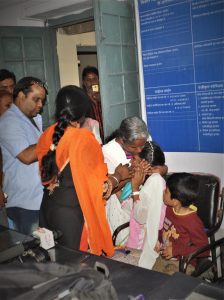 A mother tries to comfort her crying daughter, one of seven children detained at the railway police station in Indore, India, before they were separated. Hindu extremist group leader Vinod Mishra is in blue shirt. (Pawan Bhawar)