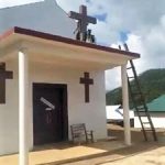A United Wa State Army (UWSA) militant begins toppling cross on church building in rebel-held territory in Shan state, Burma (Myanmar), in photo circulated on Facebook. (Morning Star News)