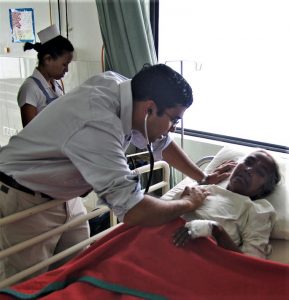 Dr. Christo Thomas Philip with heart patient at hospital in Raxaul, Bihar state, India. (Morning Star News)