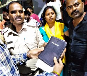 Villagers hand Bible to police in Lalpur as evidence against Christians in Ranchi, Jharkhand state, India. (Morning Star News)