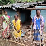Damaged home of Kanduru Muduli (right), with his mother and daughter in Badaguda, Odisha state, India. (Morning Star News)