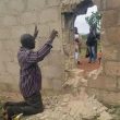 A parent prays for students abducted through breached wall at Bethel Baptist High School, Maraban Rido, Kaduna state, Nigeria on July 5, 2021. (Vincent Bodam for Morning Star News)