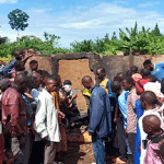 Villagers at charred home where Pastor Mukisa and family were burned to death in Namutumba District, Uganda on Oct. 13, 2024. (Morning Star News)