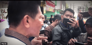 Pastor Herri Soesanto objects to manhandling at sealing of church in Jombang, East Java Province, Indonesia. (Screenshot of YouTube video)