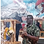 Nigerian Army representative addresses the Rev. Ezekiel Dachomo's church, offering protection. (Screenshot from YouTube)