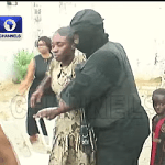 Security personnel escort one of 38 released Christians following their Nov. 21, 2025 kidnapping in Eruku village, Kwara state, Nigeria. (Screenshot from Channels TV video)