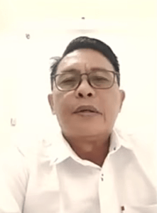 Pastor Novel Pangemanan in video call with rights group about April 14, 2026 halt to construction of prayer house in Kappuna village, North Luwu Regency, Indonesia. (Screenshot from Tanparagi video)